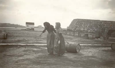 Herring Girls hauling barrels of salt herring